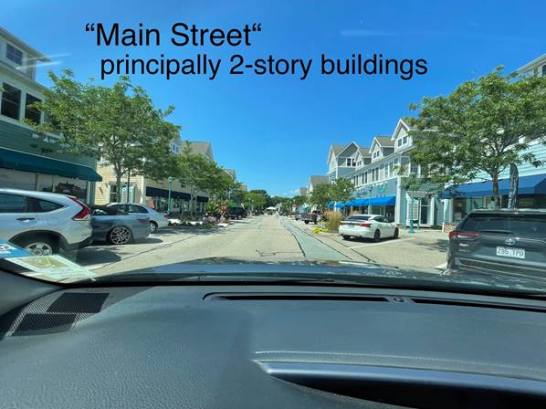 A picture containing text, outdoor, car, street

Description automatically generated